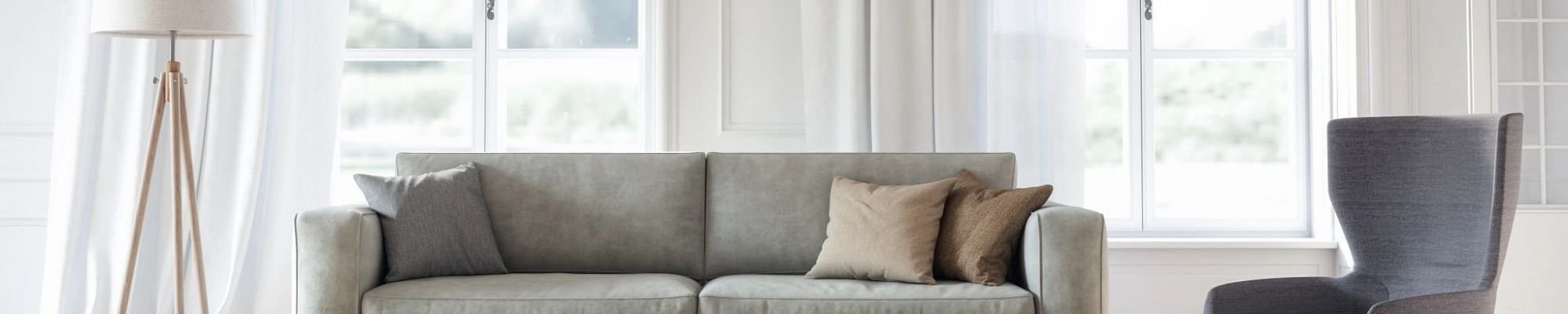 A couch and an armchair aside next to a window from Young's Interiors & Flooring in Ford City